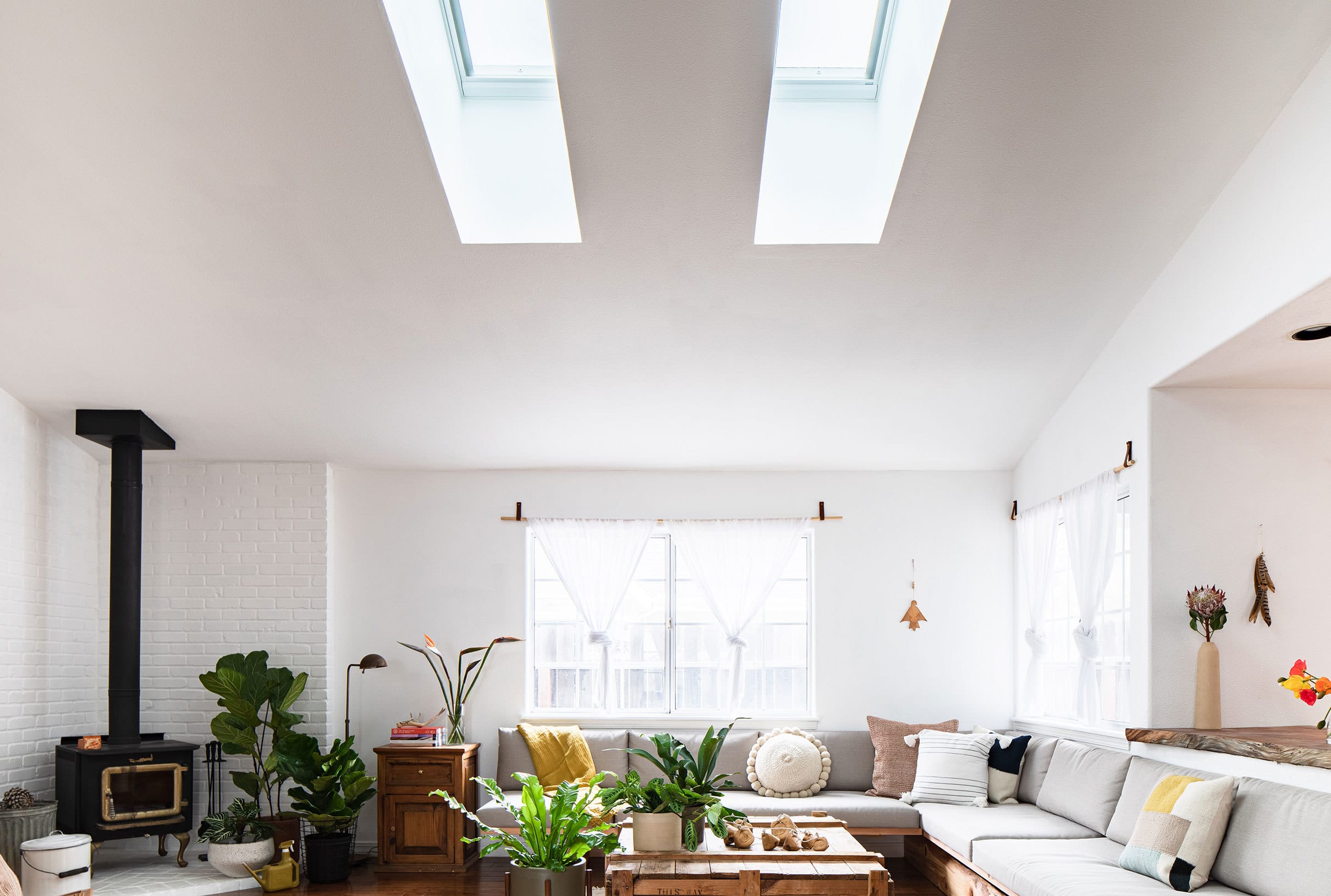 A living room with two skylights sectional sofa
