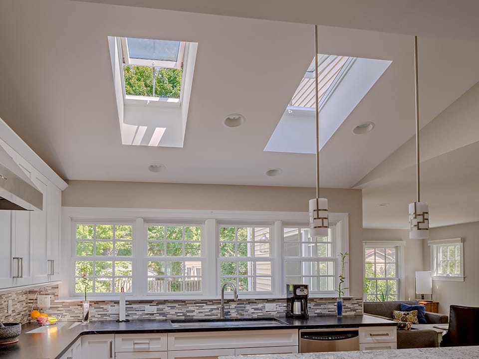 Grey and white kitchen with skylights