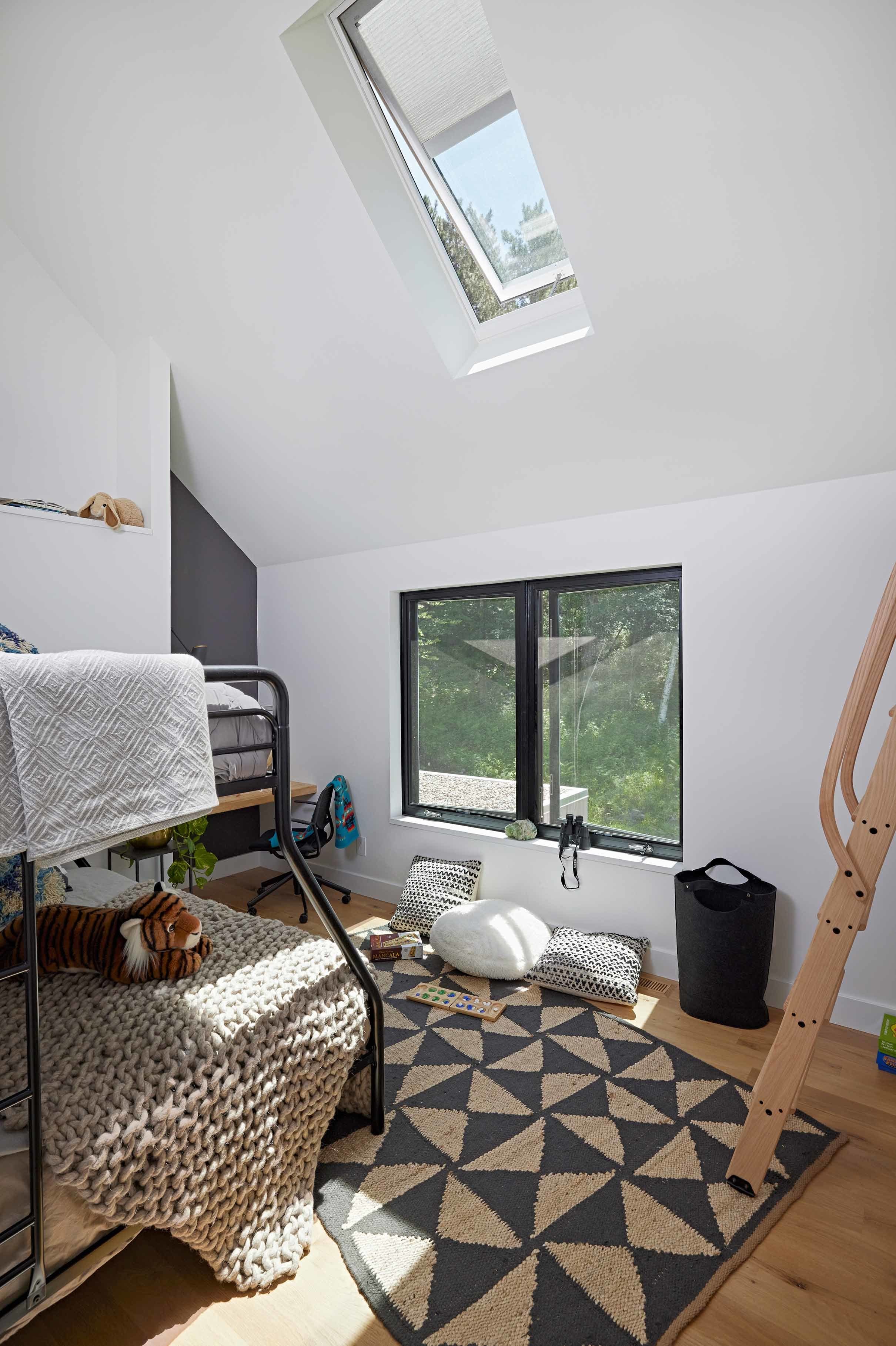Bedroom with skylight over a bunk bed