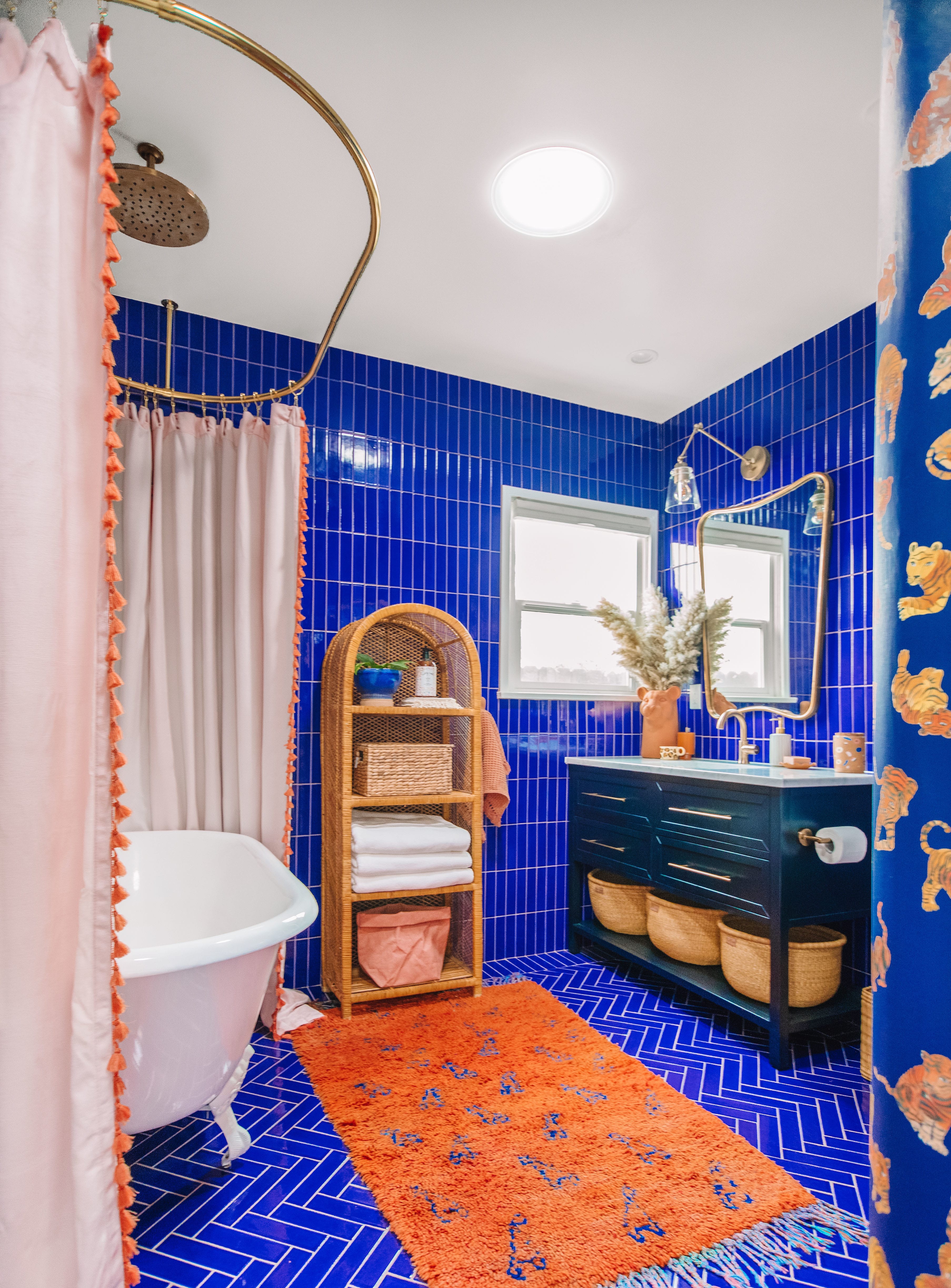 Bathroom with royal blue tile and terra cotta accents with claw foot bathtub