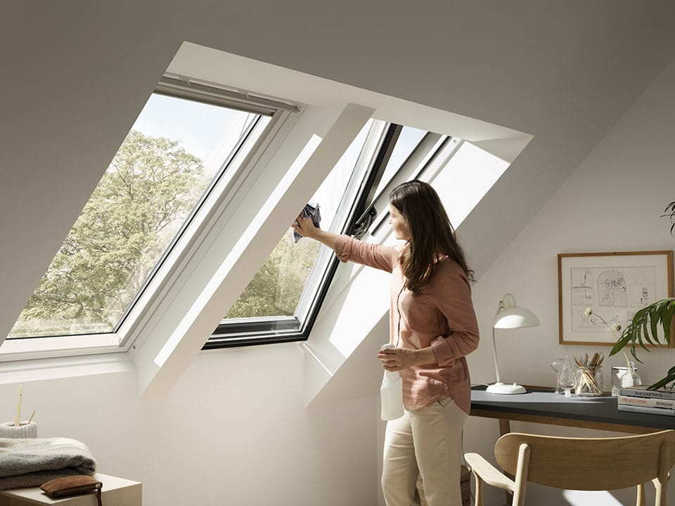 A woman cleaning a skylight.