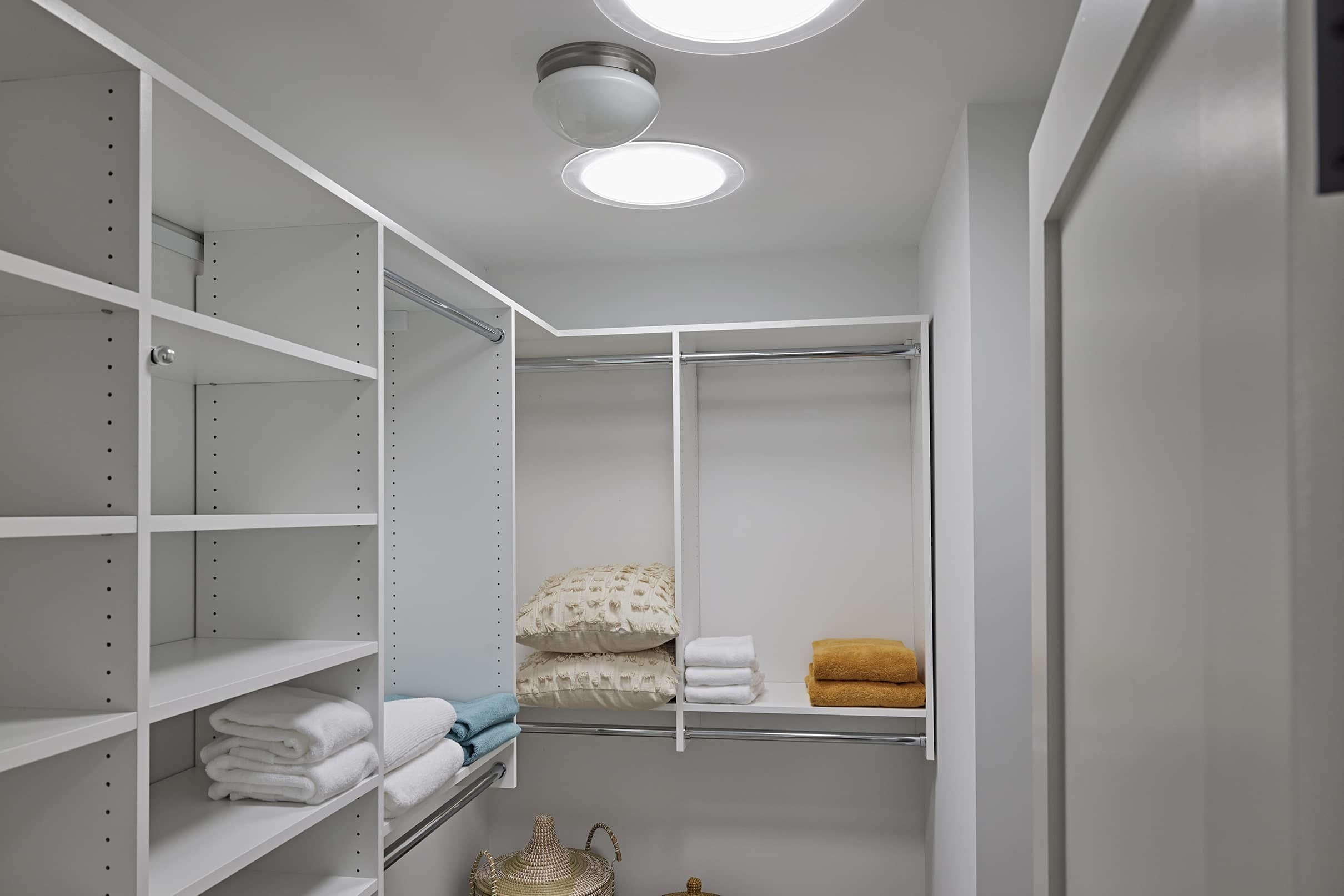 Closet white yellow towels sun tunnel skylights