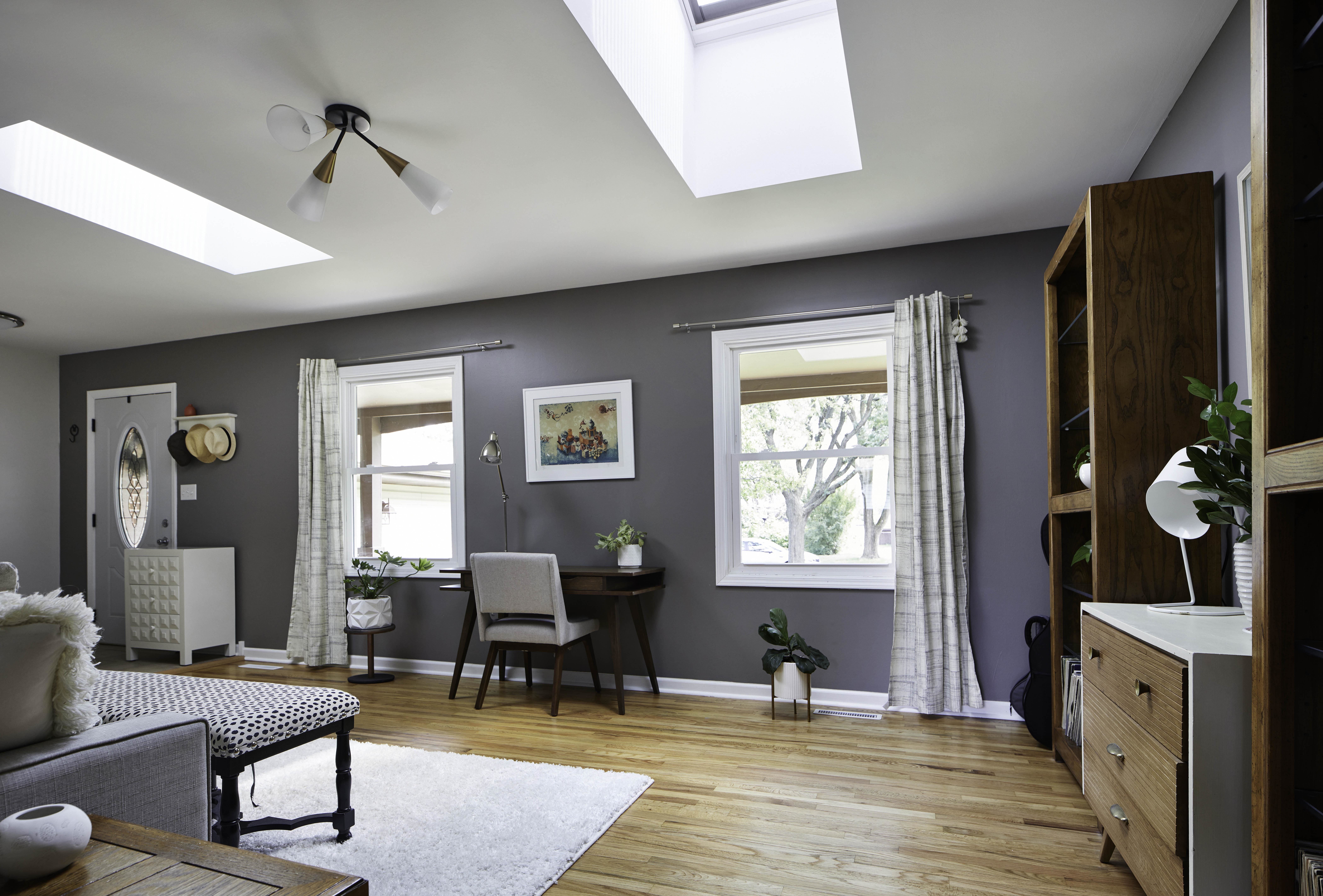 living room with two skylights and a home workspace