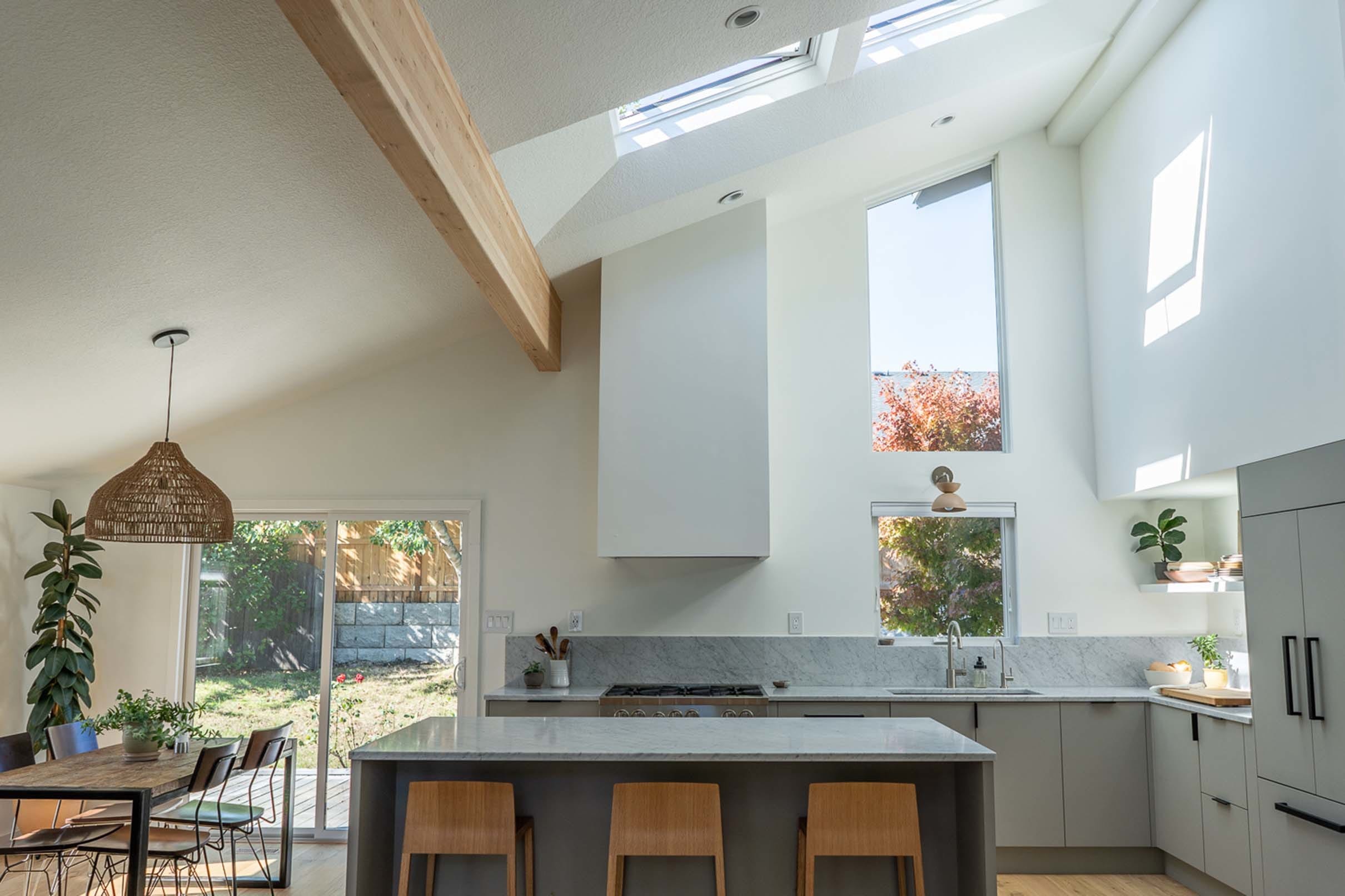 grey white and natural wood kitchen with two skylights