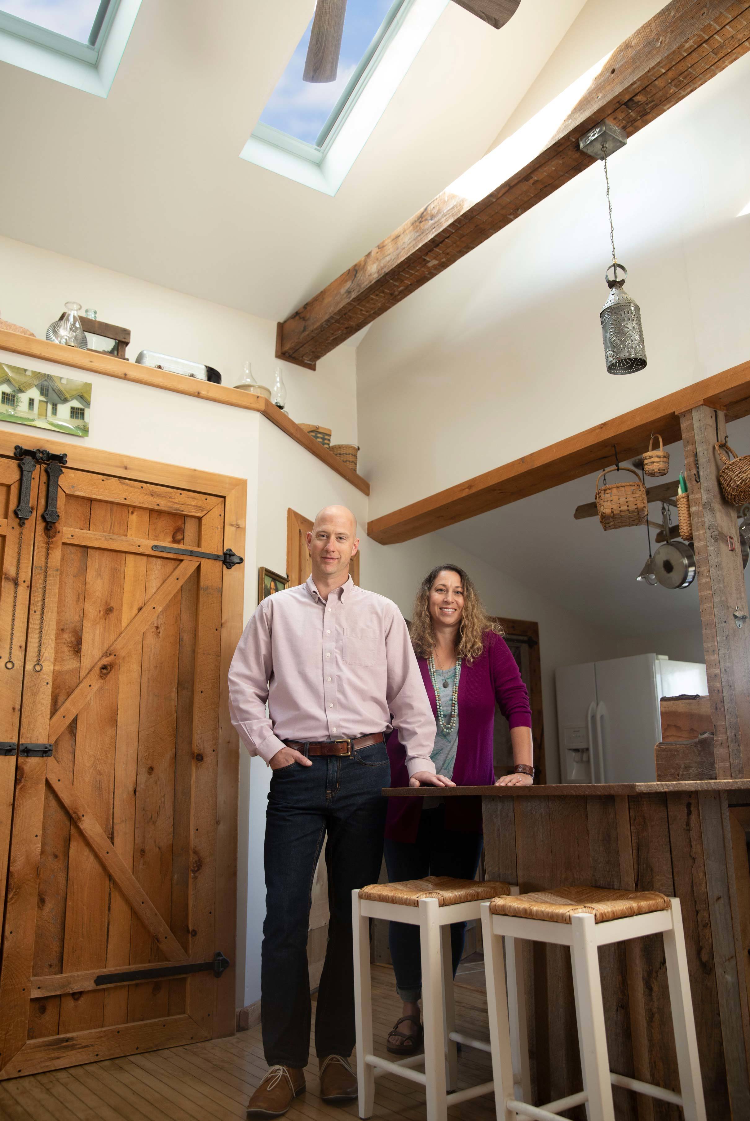 Man and woman standing under skylights in a kitchen