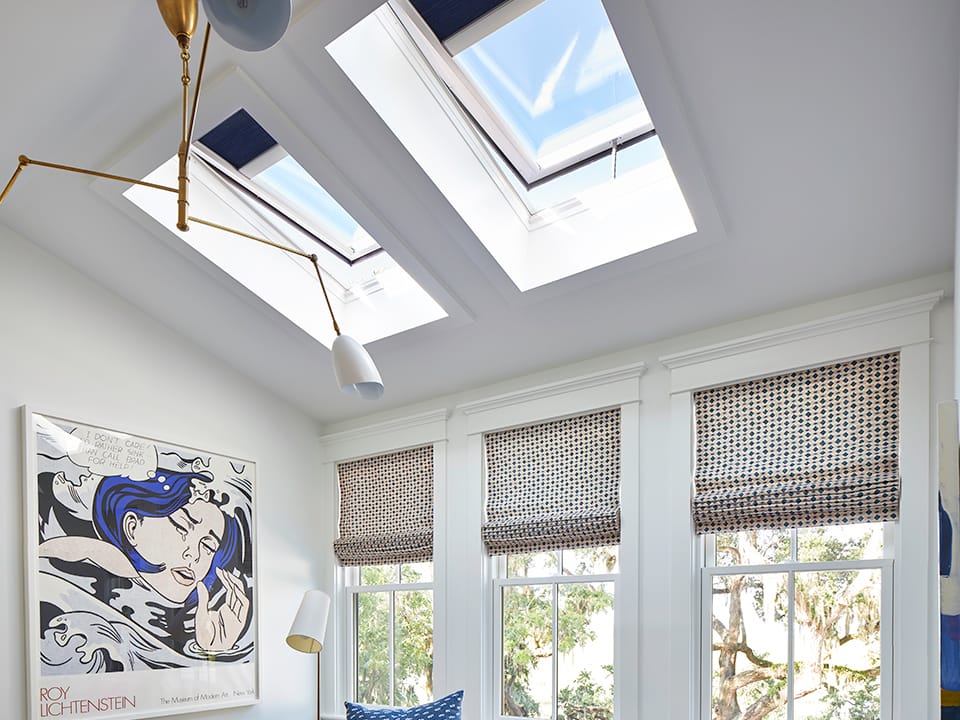 Sitting room with pink couch graphic poster and open skylights