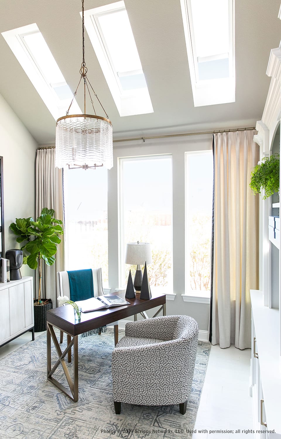 White light filled home office with skylights, windows and ceiling to floor draperies
