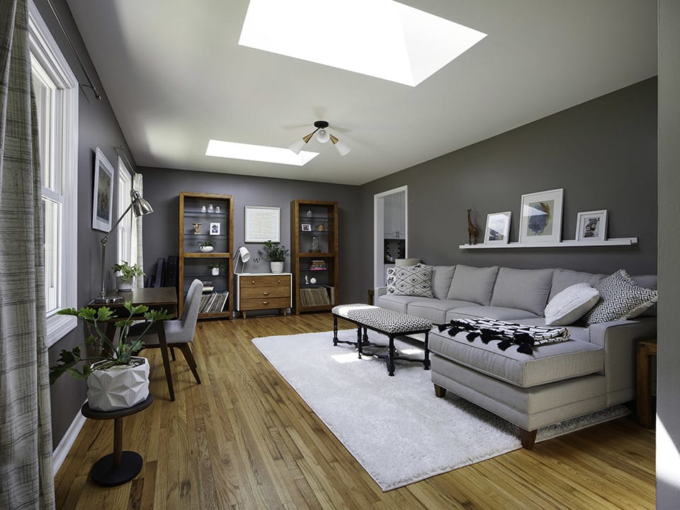 Skylights bring natural light into this dark gray living room.