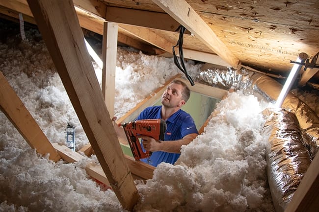 Skylight installer nails timber framing to reinforce the light shaft