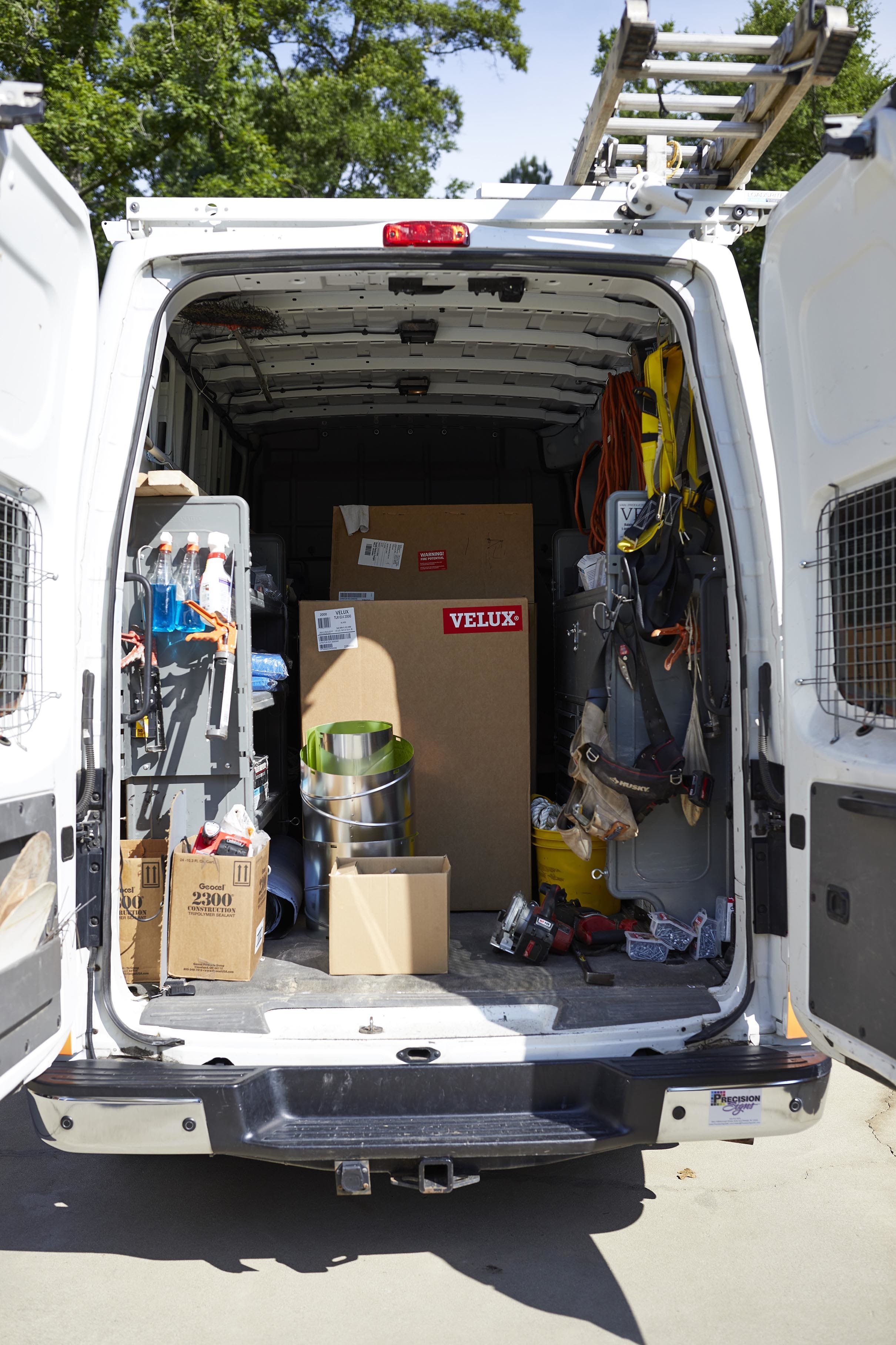 Skylight installer work van packed with gear