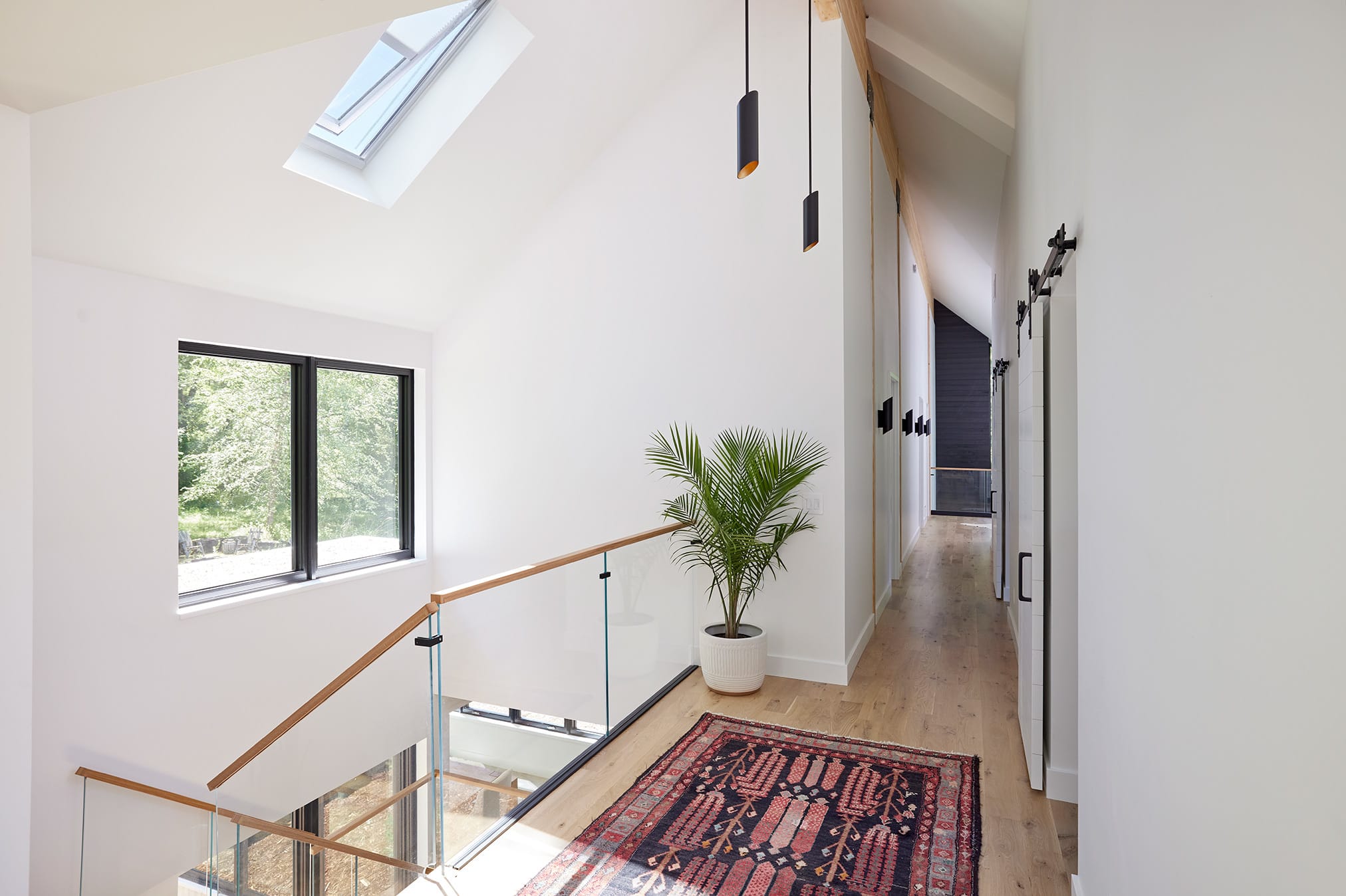 A minimalist stairwell brightened by a skylight