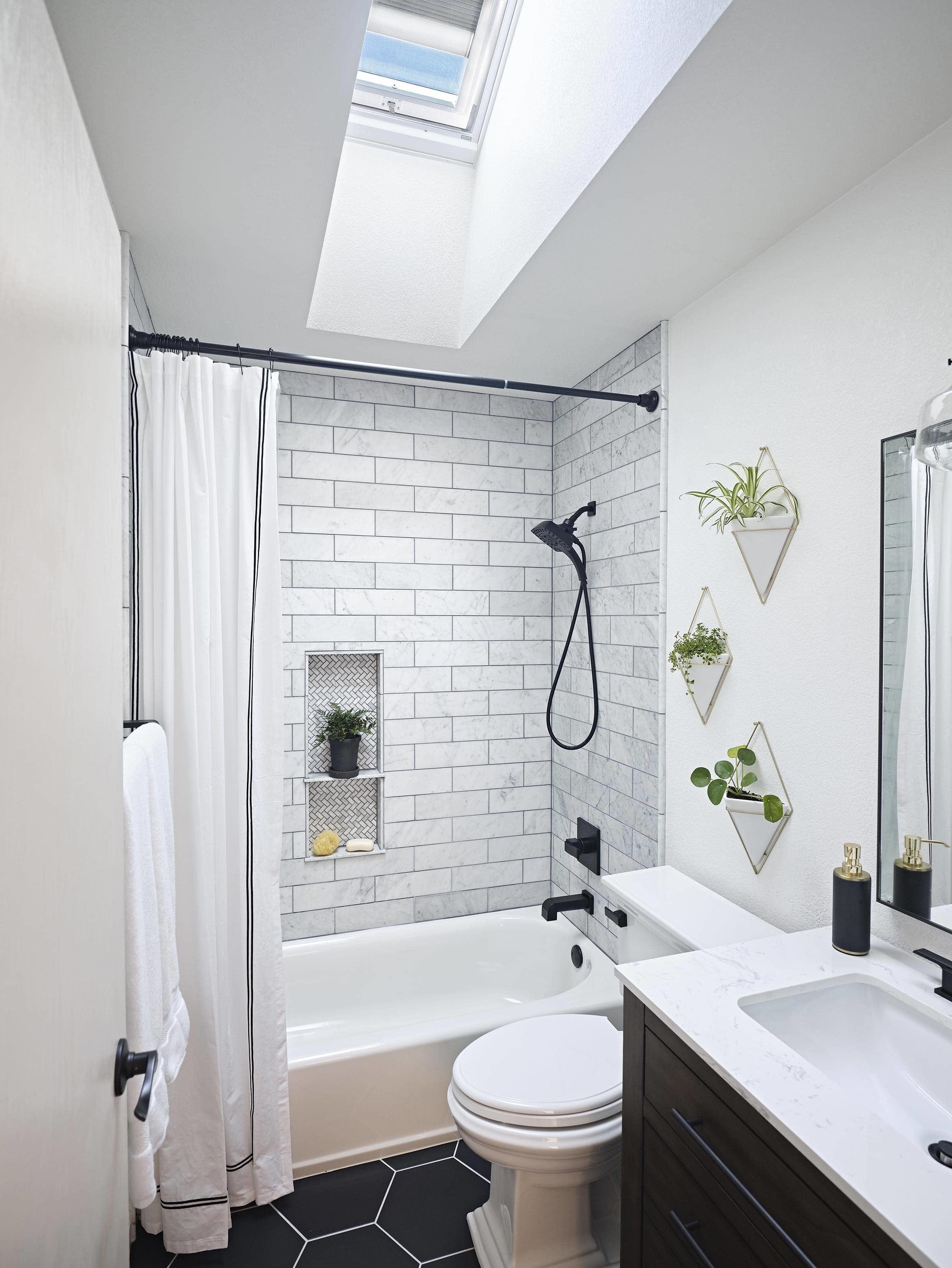 Small bathroom skylight black tile