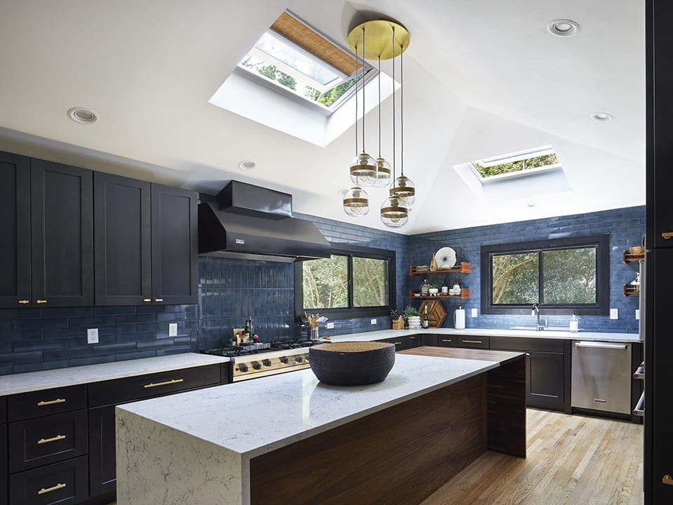 A skylight brightens a small bathroom that features bold colors