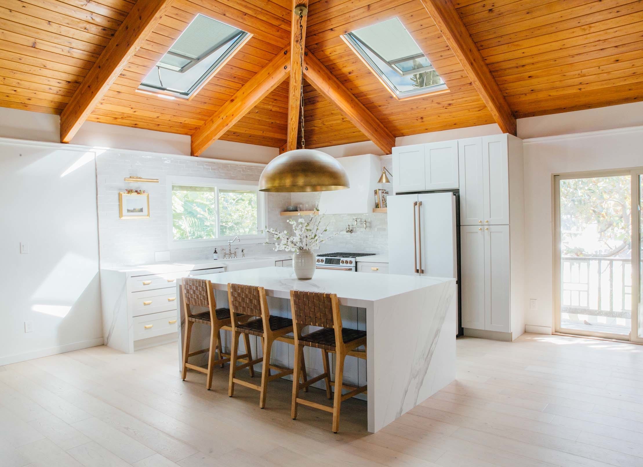 White kitchen brass light fixture skylights