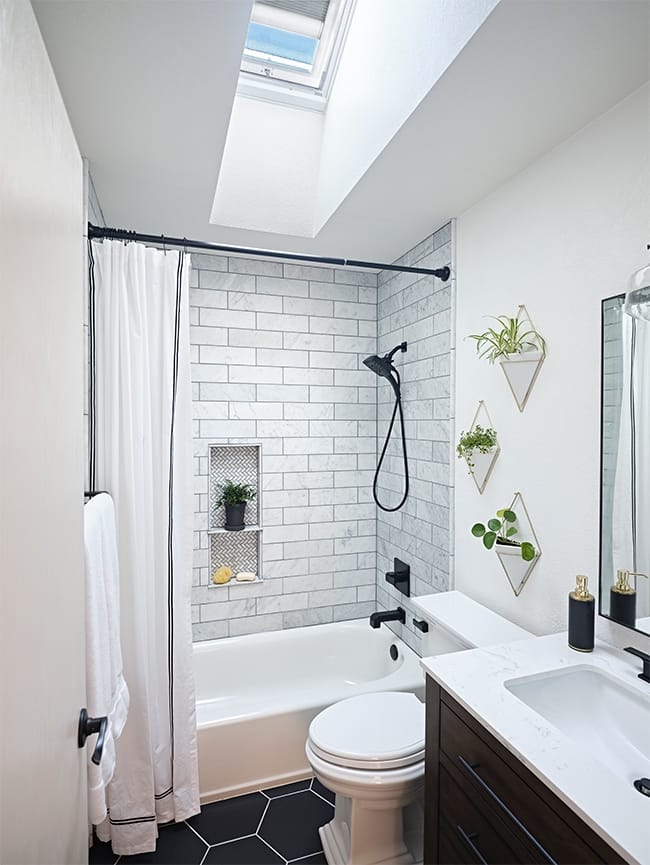 Bathroom with skylight over bathtub