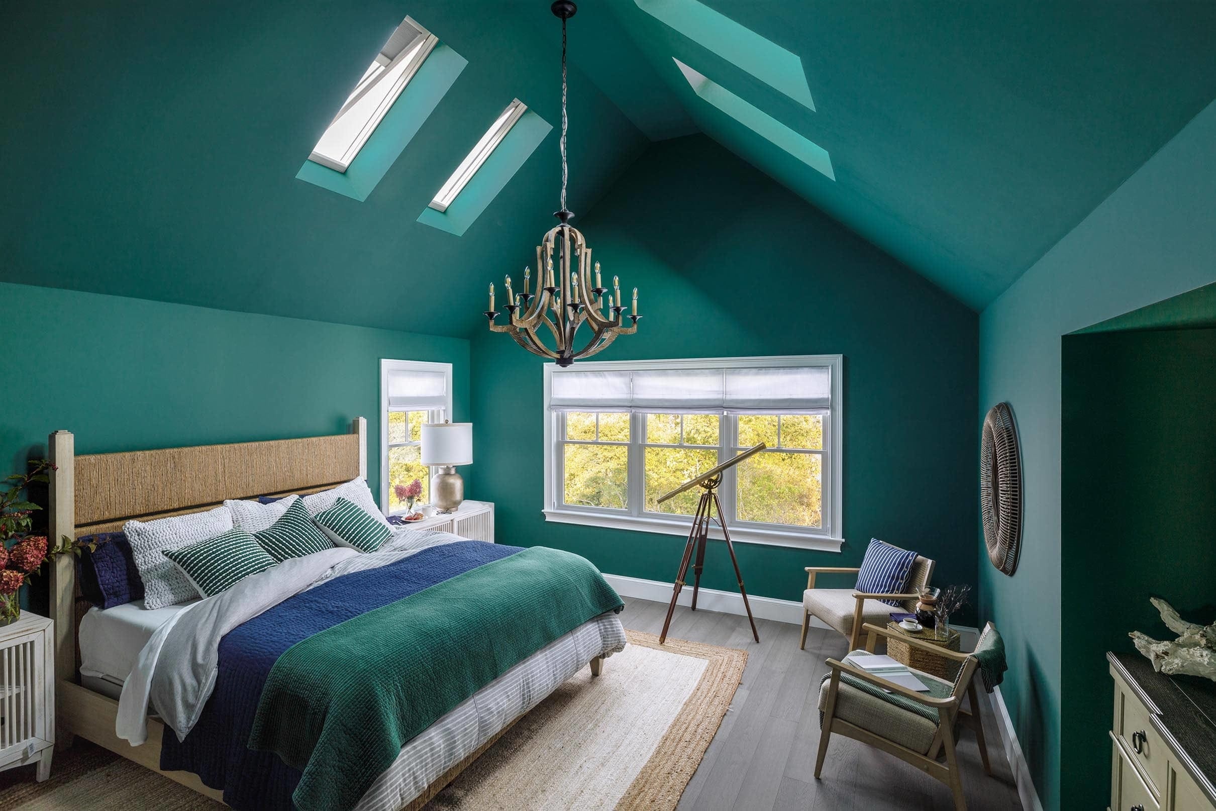 Bedroom painted dark green with four skylights