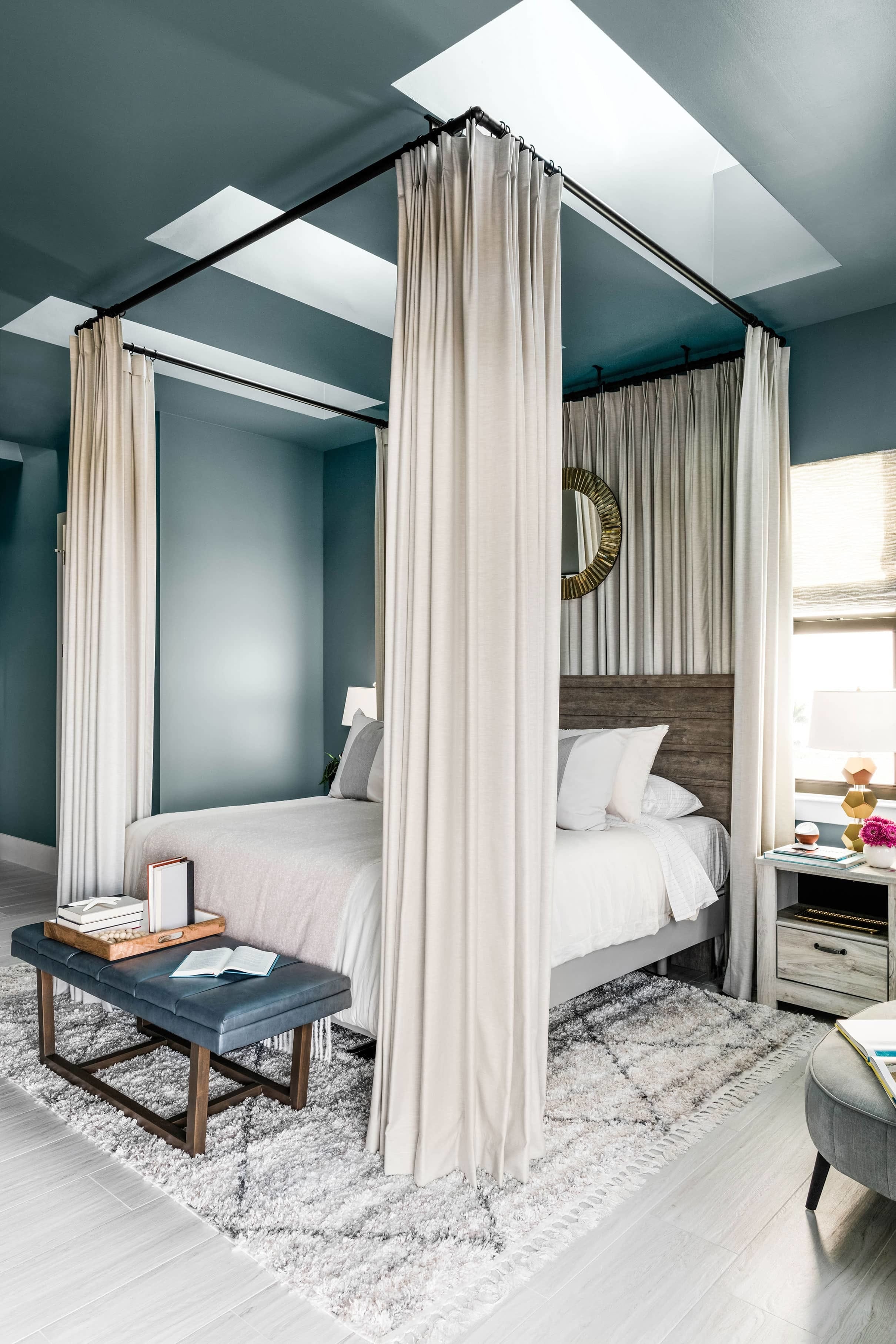 Bedroom skylights blue walls taupe draped bed