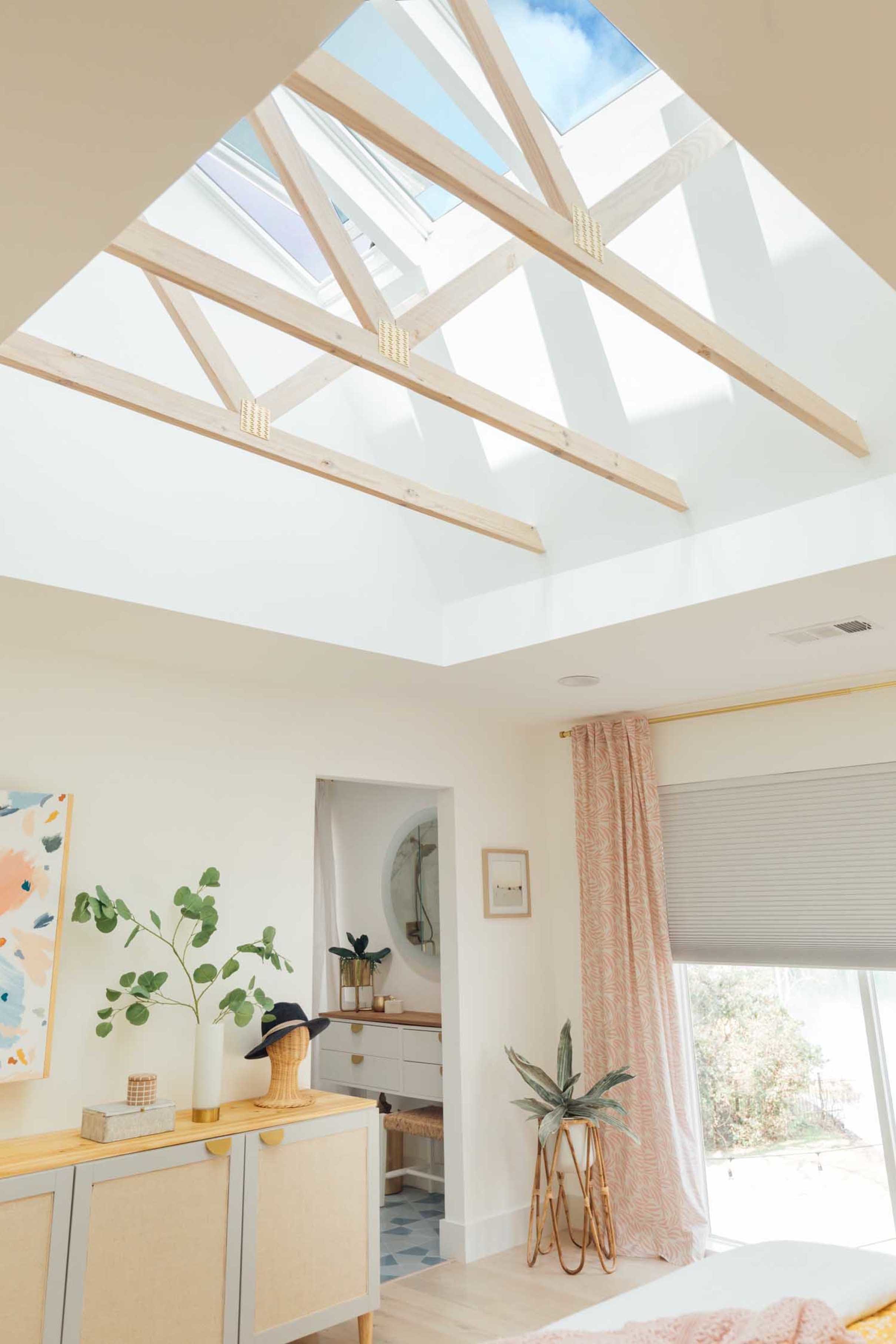 Bedroom skylights exposed trusses pink yellow