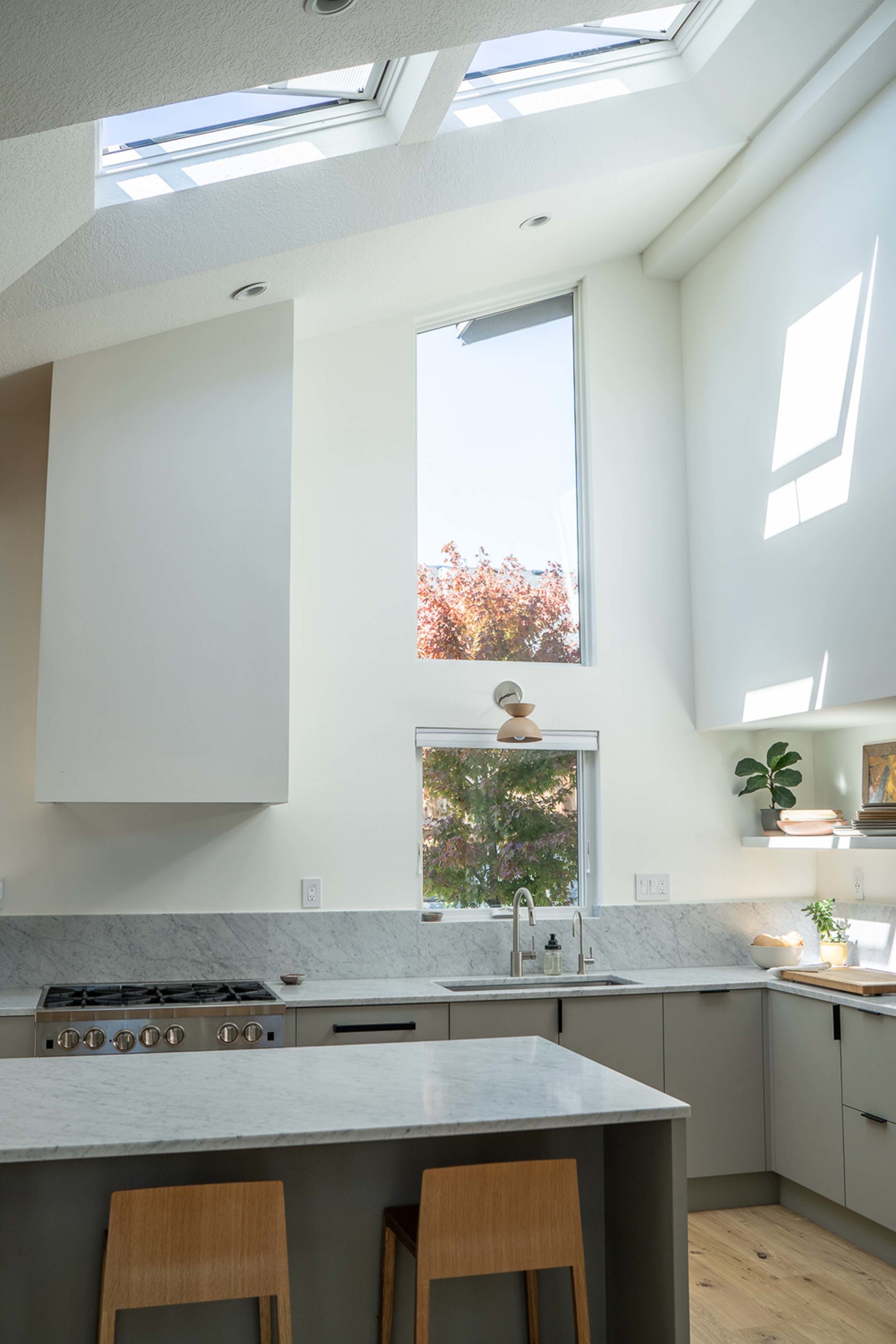 Kitchen white gray skylights island