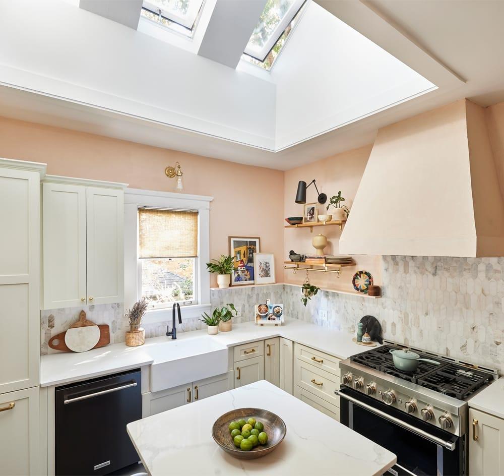 Open plan kitchen with two skylights in a wood-clad ceiling