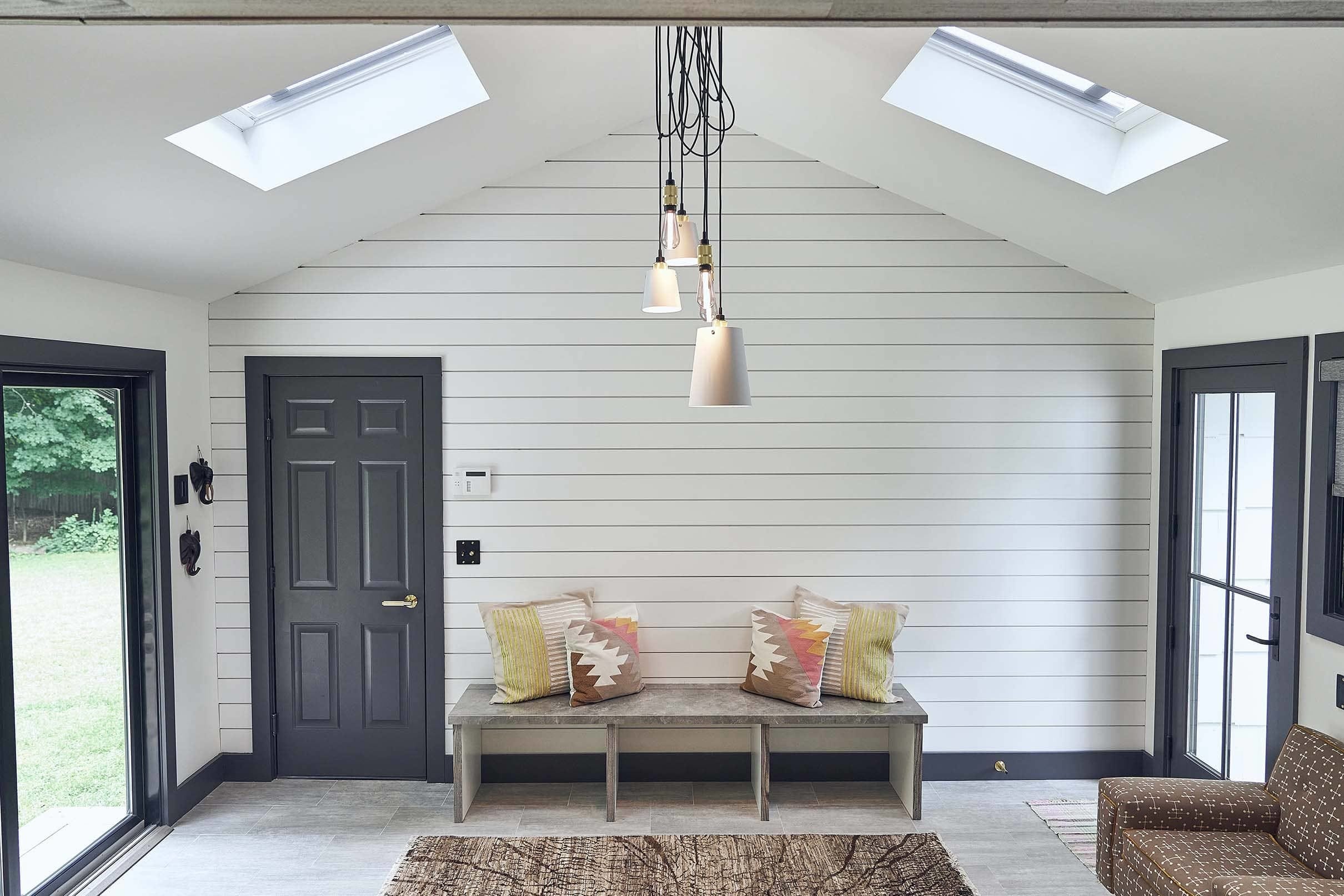 Mud room white gray skylights bench