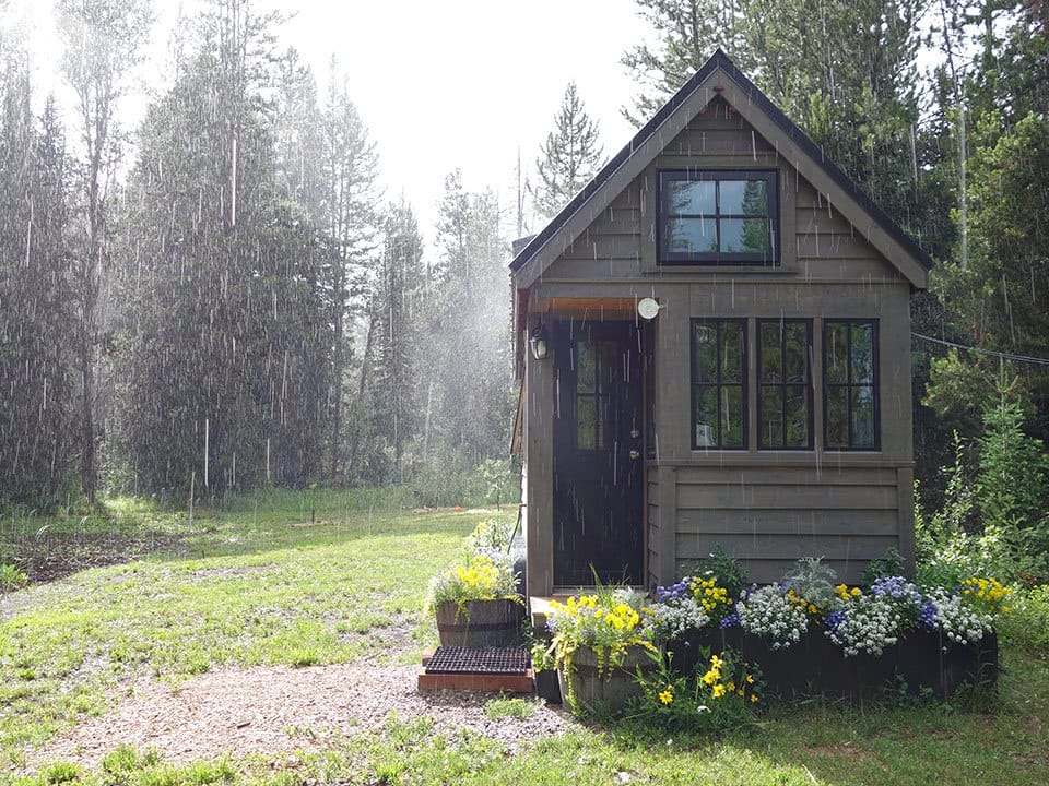 Wood siding tiny house in the rain